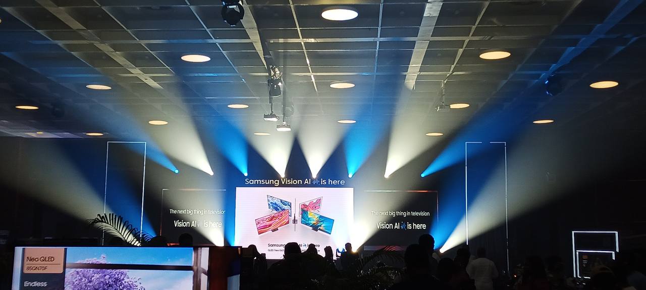Corporate product presentation with LED screens and blue and white stage lighting